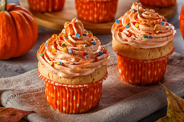istock Pumpkin cupcakes with glitter sugar sprinkles. 621114060