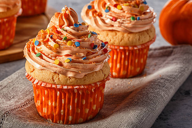istock Pumpkin cupcakes with glitter sugar sprinkles. 621114102