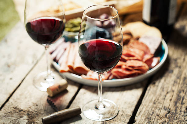 Red wine Red wine with charcuterie assortment on the background auvergne rhône alpes photos stock pictures, royalty-free photos & images