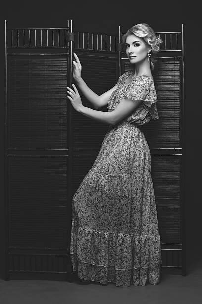 istock Beautiful girl standing near folding screen 621114492