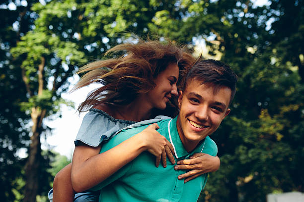 istock man carries a girl on his back 621115050