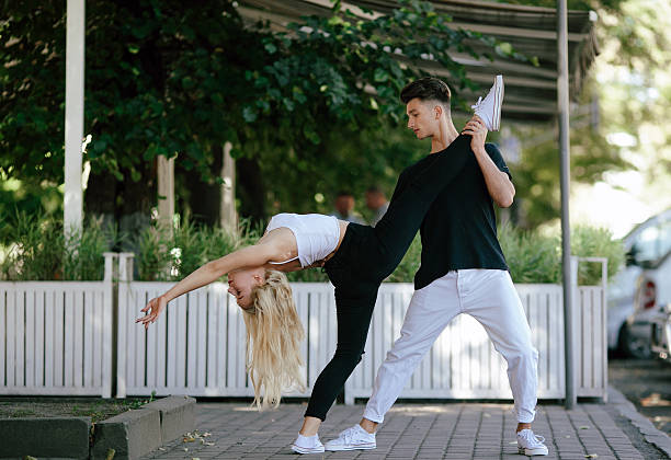 istock man and woman dancing in a park 621116306