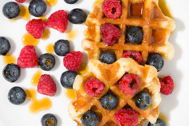 istock Close-up of waffles with berries and maple syrup 621116896