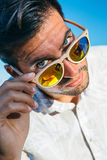 istock Portrait of stylish man looking over glasses 621117270