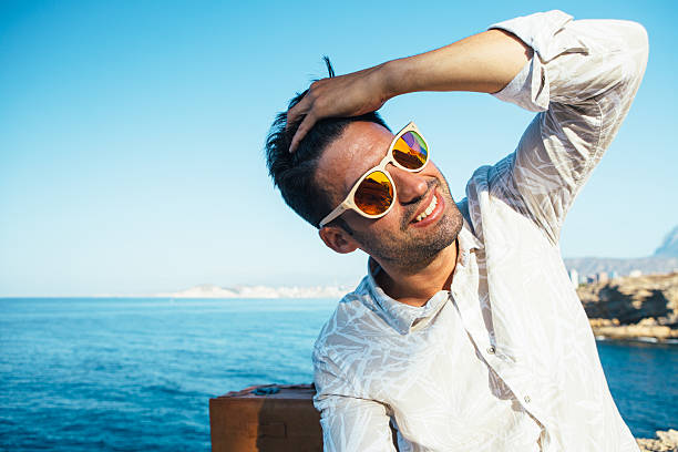 istock Handsome man in sunglasses enjoying in sunlight 621117398