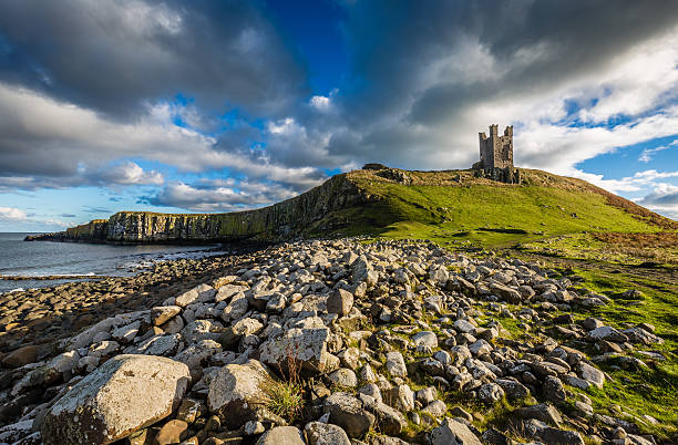 Dunstanburgh Castle ruins Dunstanburgh Castle ruins, Northumberland, England craster stock pictures, royalty-free photos & images