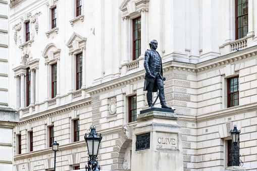 Equestrian Statue of The Duke of Wellington at Hyde Park Corner in City of Westminster, London. It was completed by Joseph Edgar Boehm in 1888. In the background are people and Apsley House. On the right two men are sitting.