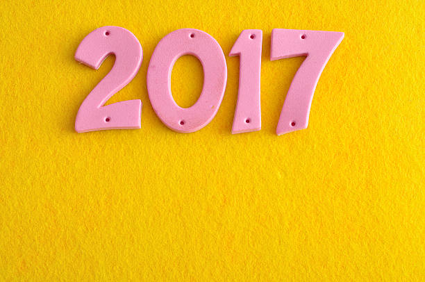 istock 2017 in pink numbers isolated against a yellow background 621120166
