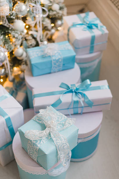 istock Christmas gift boxes with blue bow and bokeh lights on 621121796