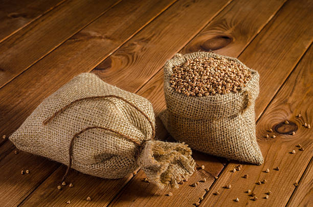 istock Buckwheat in bags on a wooden table 621125022