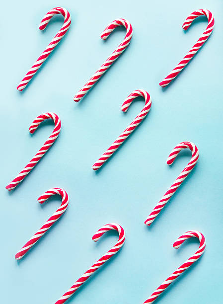 istock Christmas candy cane on blue background.  Flat lay. Top view. 621125302