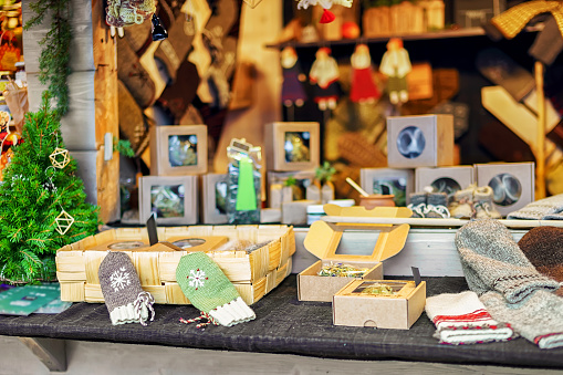 Handmade souvenirs and knitted gloves displayed for sale at the stand during the Christmas market in Riga, Latvia. The fair takes place each year from December till the beginning of January.