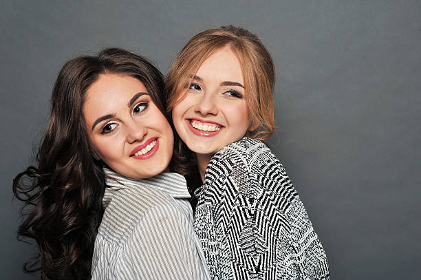 istock young beautiful brunette and blond haired girls 621128092