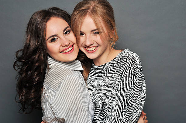 istock young beautiful brunette and blond haired girls 621128150