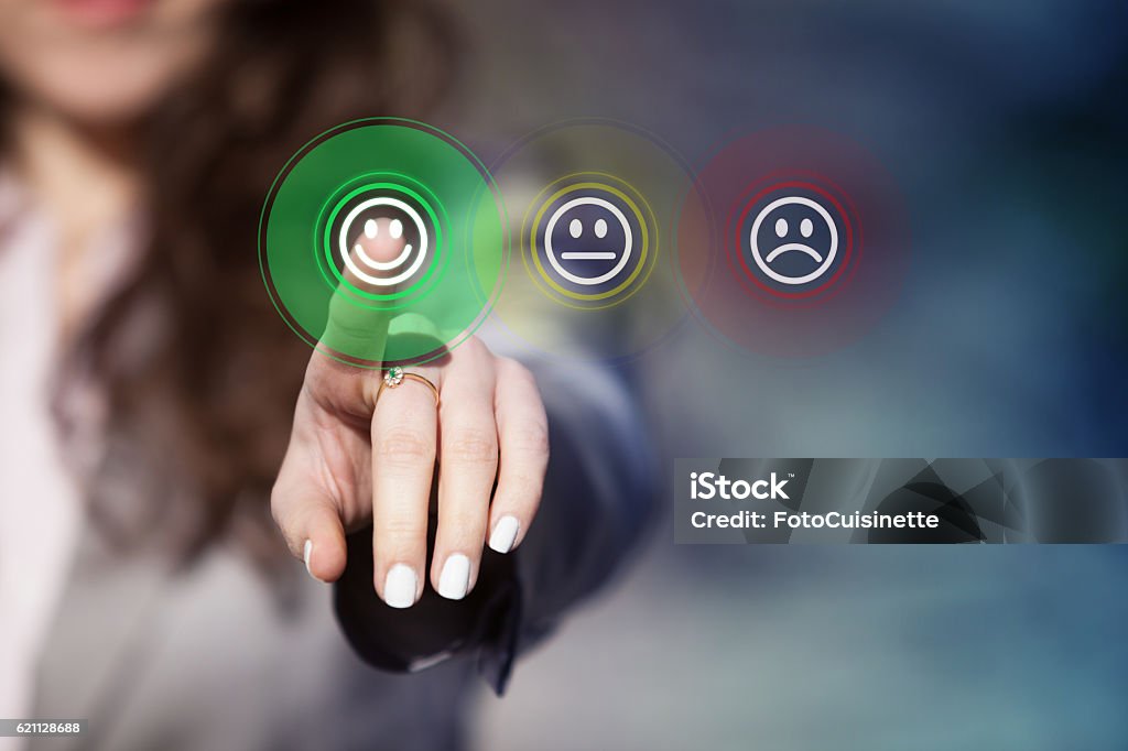 Customer service evaluation. Businesswoman pressing smiley face emoticon on virtual touch screen. Customer service evaluation concept. Customer Stock Photo