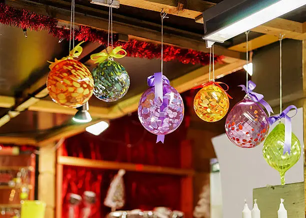 Photo of Colorful glass decorations hanging for sale at Riga Christmas market