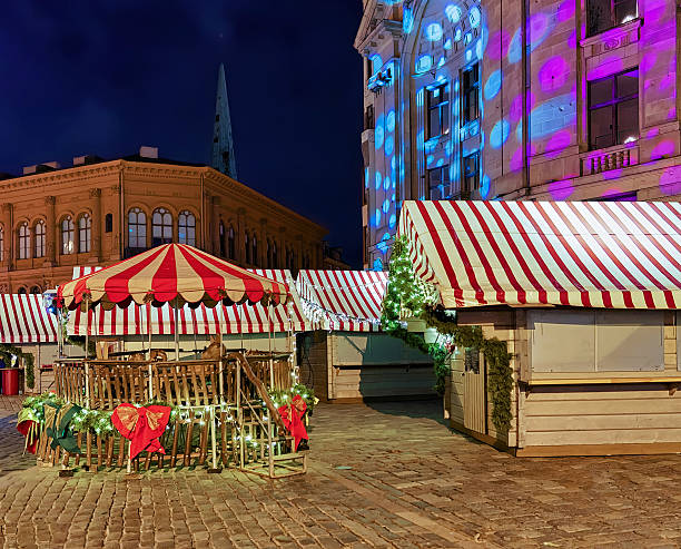 istock Christmas stands at the market in old Riga 621128894