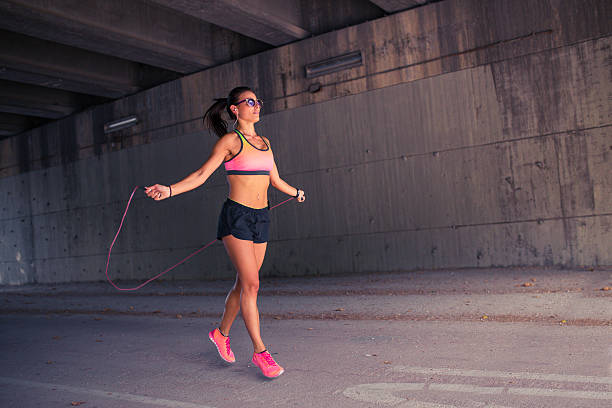 istock Fit woman runner warming up outdoors 621129810