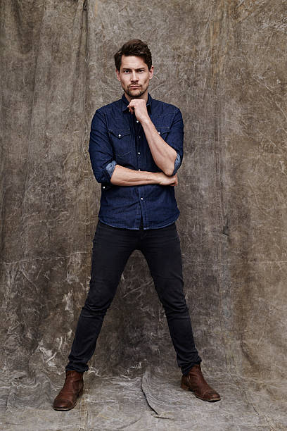 istock Man in jeans and shirt posing for camera 621131794