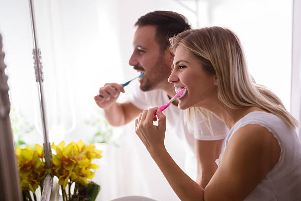 istock Couple washing teeth in morning 621132496