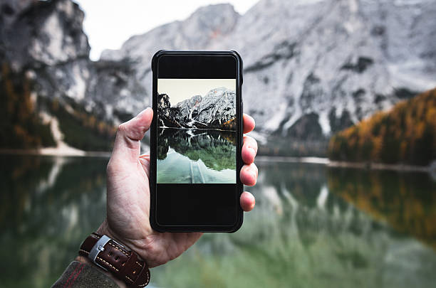 Photographing the Braies lake in south tyrol with the smartphone Photographing the Braies lake in south tyrol with the smartphone nature reserve photos stock pictures, royalty-free photos & images