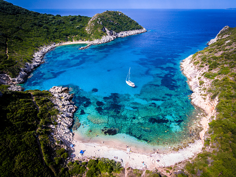 Porto Timoni, on of the hidden beaches of Corfu Island, also known as Kerkyra, near Agios Giorgios beach. Turqoise waters, summer aerial view from drone.