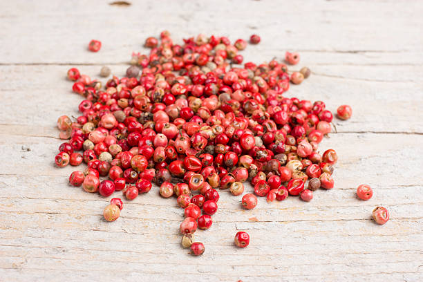 istock Peppercorns close up on wood 621137154