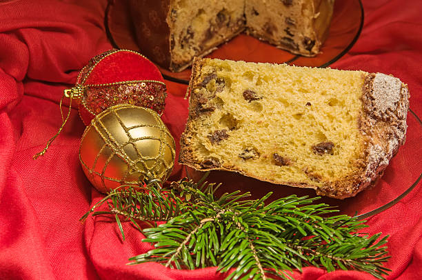 istock Cut panettone, branch of pine tree and baubles. Christmas theme. 621137694