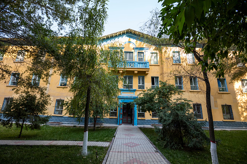 Campus view of the trees and office building.