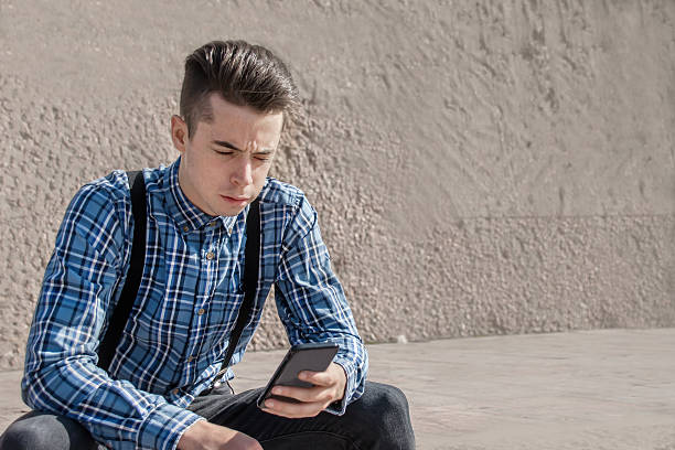 istock Man using his phone in the street 621142554