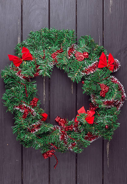 istock Christmas wreath on a rustic wooden front door. 621146420