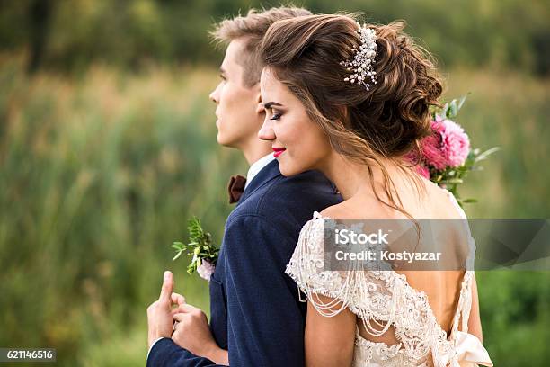 Bride And Groom Embracing In The Park Stock Photo - Download Image Now - Bride, Groom - Human Role, Wedding