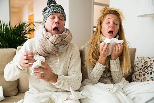 Sick couple catch cold Sick couple catch cold. Man and woman sneezing, coughing. People got flu, having runny nose. cold virus stock pictures, royalty-free photos & images
