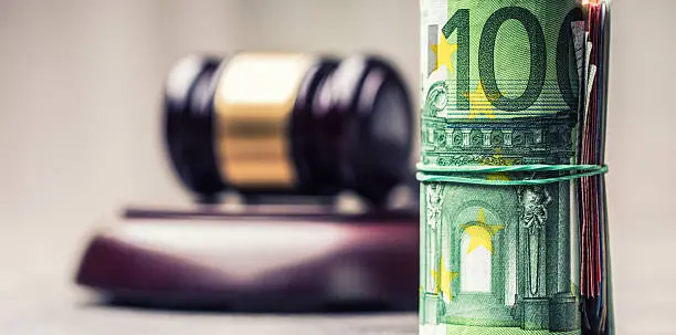 Judge's hammer gavel. Justice and euro money. Euro currency. Court gavel and rolled Euro banknotes. Representation of corruption and bribery in the judiciary.