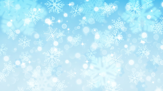 Christmas background of fuzzy and focused snowflakes