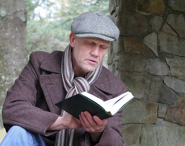 istock Mature man reading outdoors 621235276