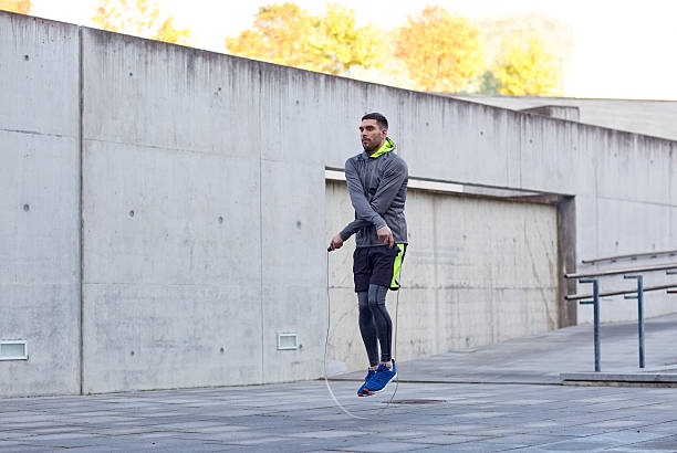 istock man exercising with jump-rope outdoors 621235436
