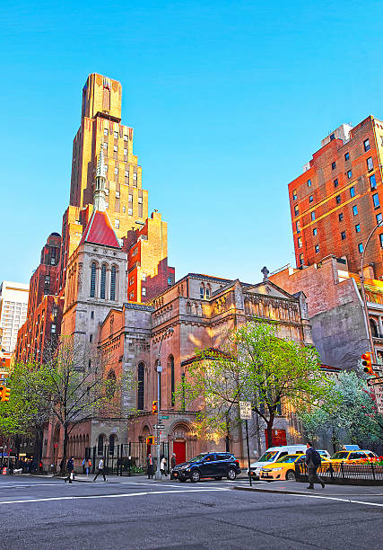 Street view on Church of Our Saviour in Manhattan New York, United States - April 24, 2015: Church of Our Lady in Midtown Manhattan. Tourists in the street. Intersection of Park Avenue and 38th East Street new york state license plate stock pictures, royalty-free photos & images