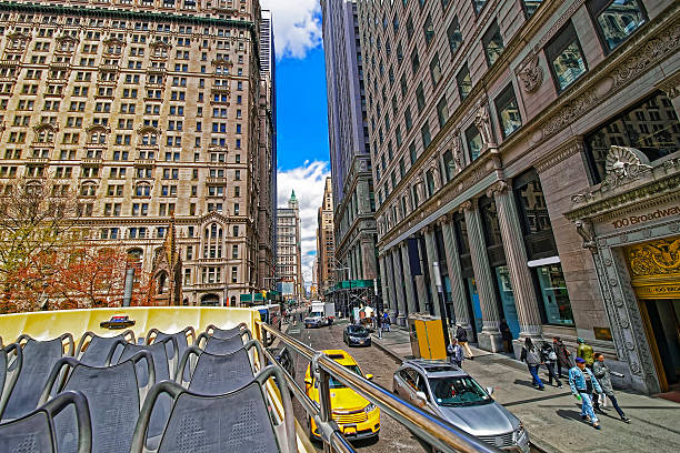 100 Broadway street in Midtown Manhattan New York, United States - April 24, 2015: 100 View from excursion bus on Broadway street in Midtown Manhattan, New York, USA. Tourists on the street. new york state license plate stock pictures, royalty-free photos & images