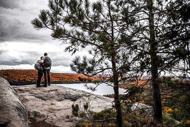 istock Young couple hiking in mountain looking at view 621239732