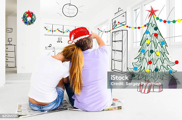 Couple Planning To Decorate New Apartment Stock Photo - Download Image Now - Christmas, Planning, Adult