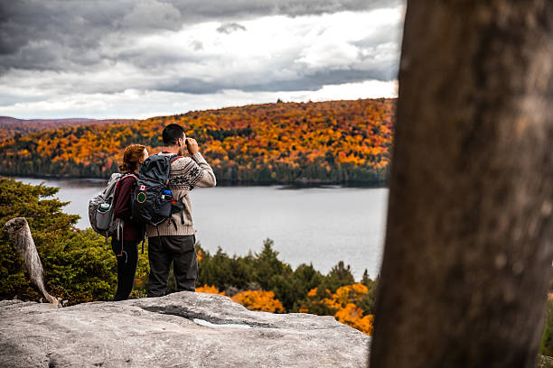 istock Young couple hiking in mountain looking at view 621242198