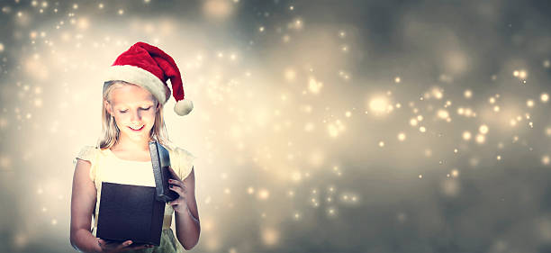 istock Girl with Santa Hat Opening Gift Box 621243164