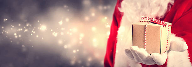 istock Santa Claus holding gift 621243186