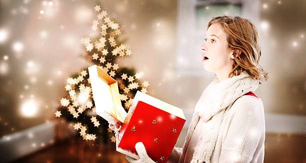istock Happy woman opening a Christmas present box 621243230