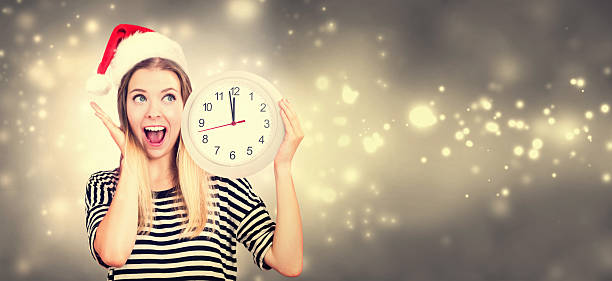istock Woman holding clock showing nearly 12 621243436