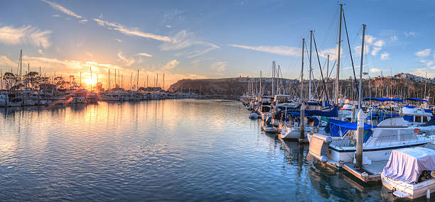 Sunset over sailboats in Dana Point harbor Sunset over sailboats in Dana Point harbor in the fall. dana point stock pictures, royalty-free photos & images