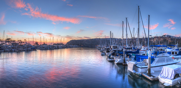 Sunset over sailboats in Dana Point harbor in the fall.