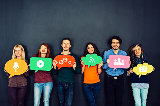 Group of young people in front of blackboard and social media concept