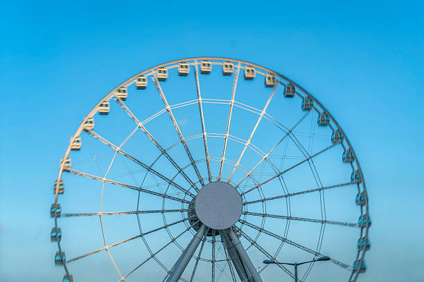 istock big ferris wheel isolated under blue sky 621246562